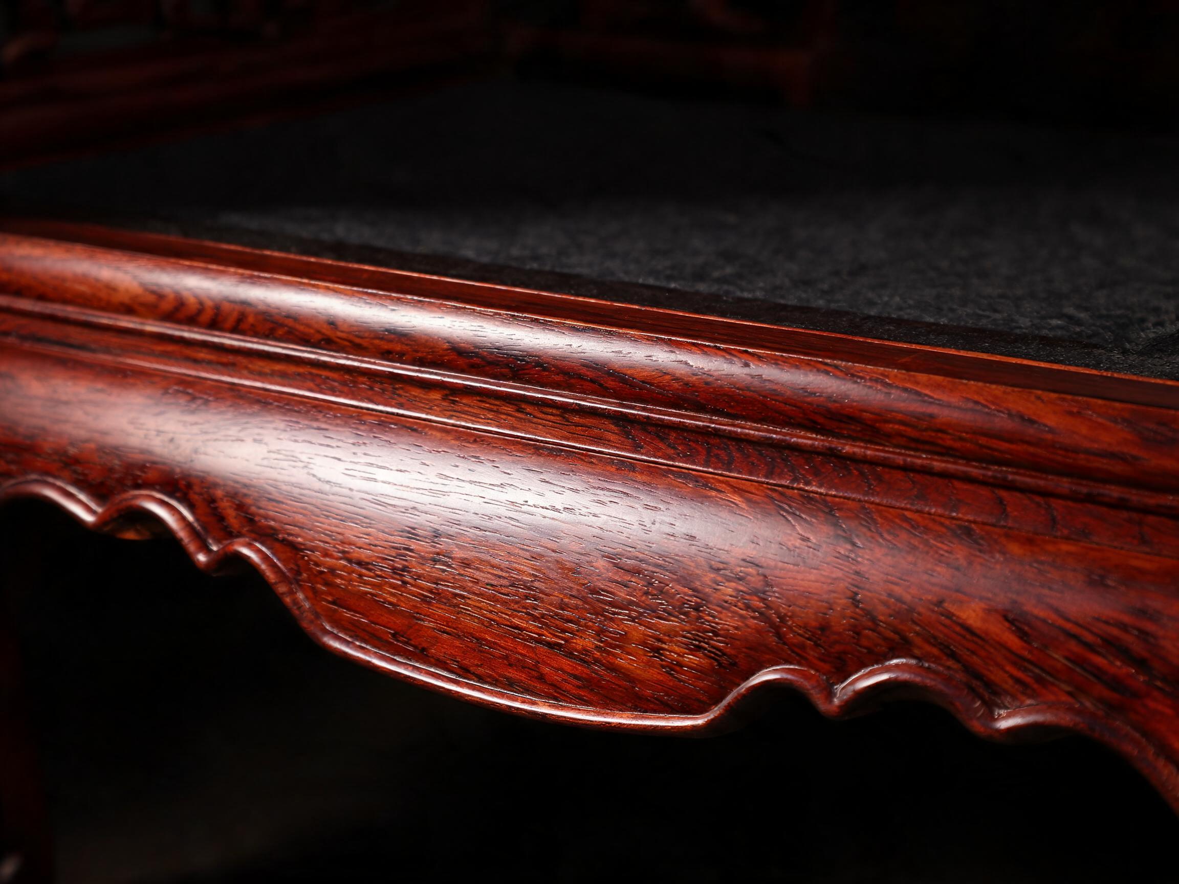 Nine-coat hand-rubbed raw lacquer finish with deep satin sheen on a carved rosewood sofa rail