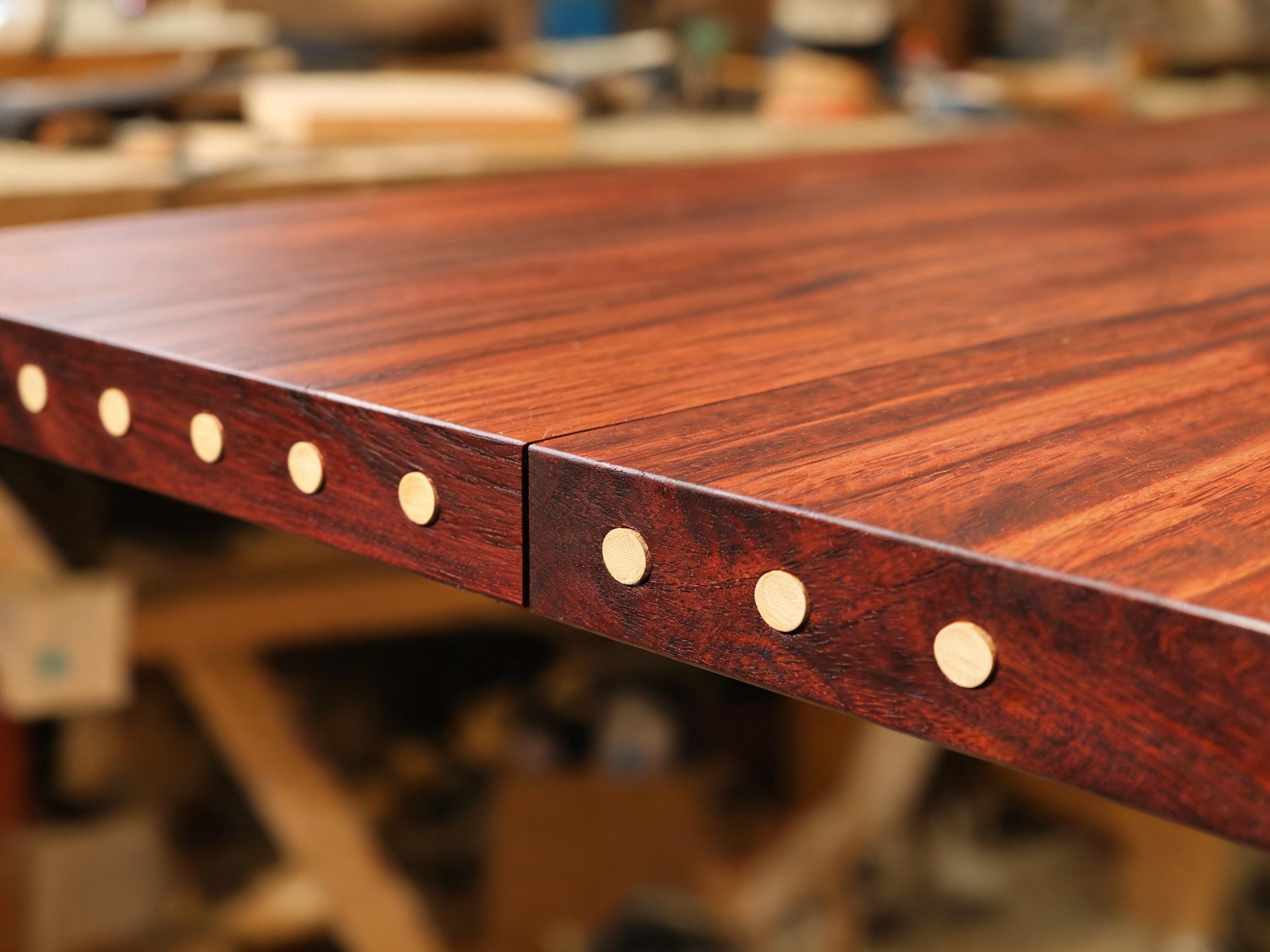 Edge-joined square rosewood tabletop with flush bamboo dowel pins along the seam