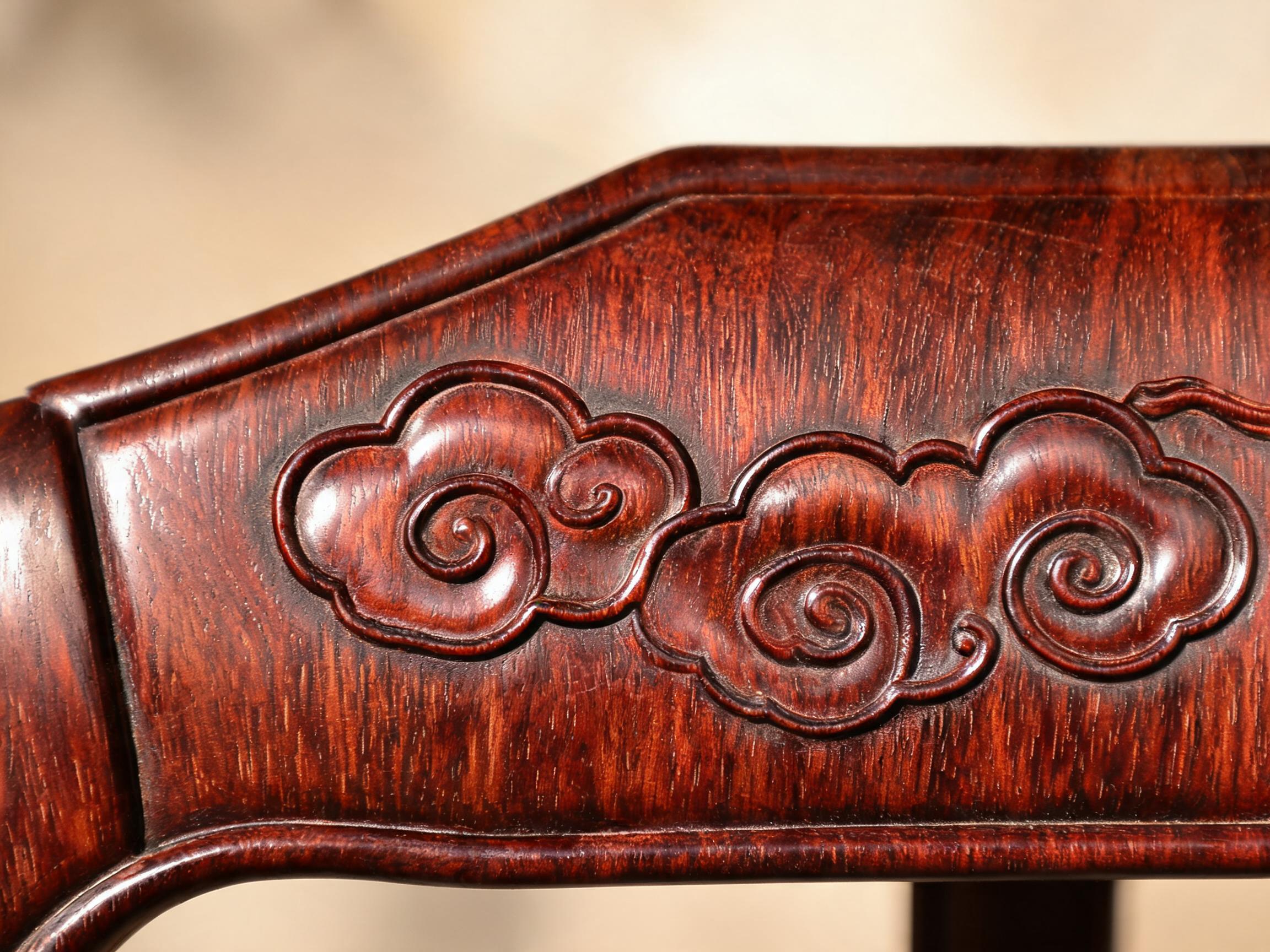 Hand-carved auspicious cloud motif on a Siamese rosewood chair backrest, shallow relief carving 3 to 5 mm deep