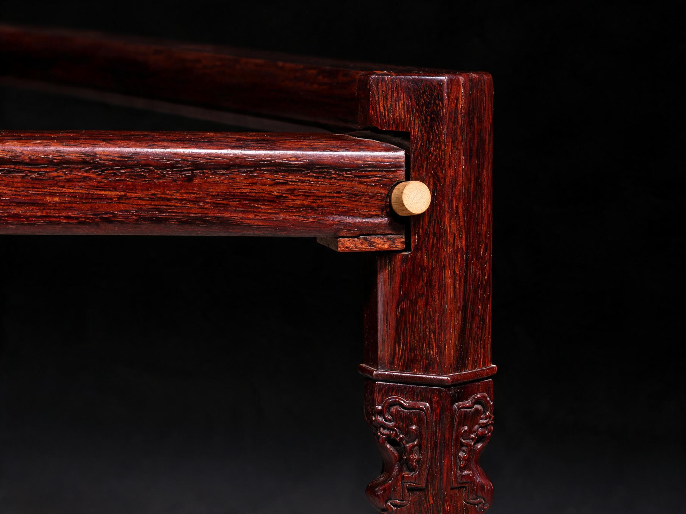 Mortise-and-tenon corner joint with bamboo dowel pin and carved foot detail on the square tea table leg