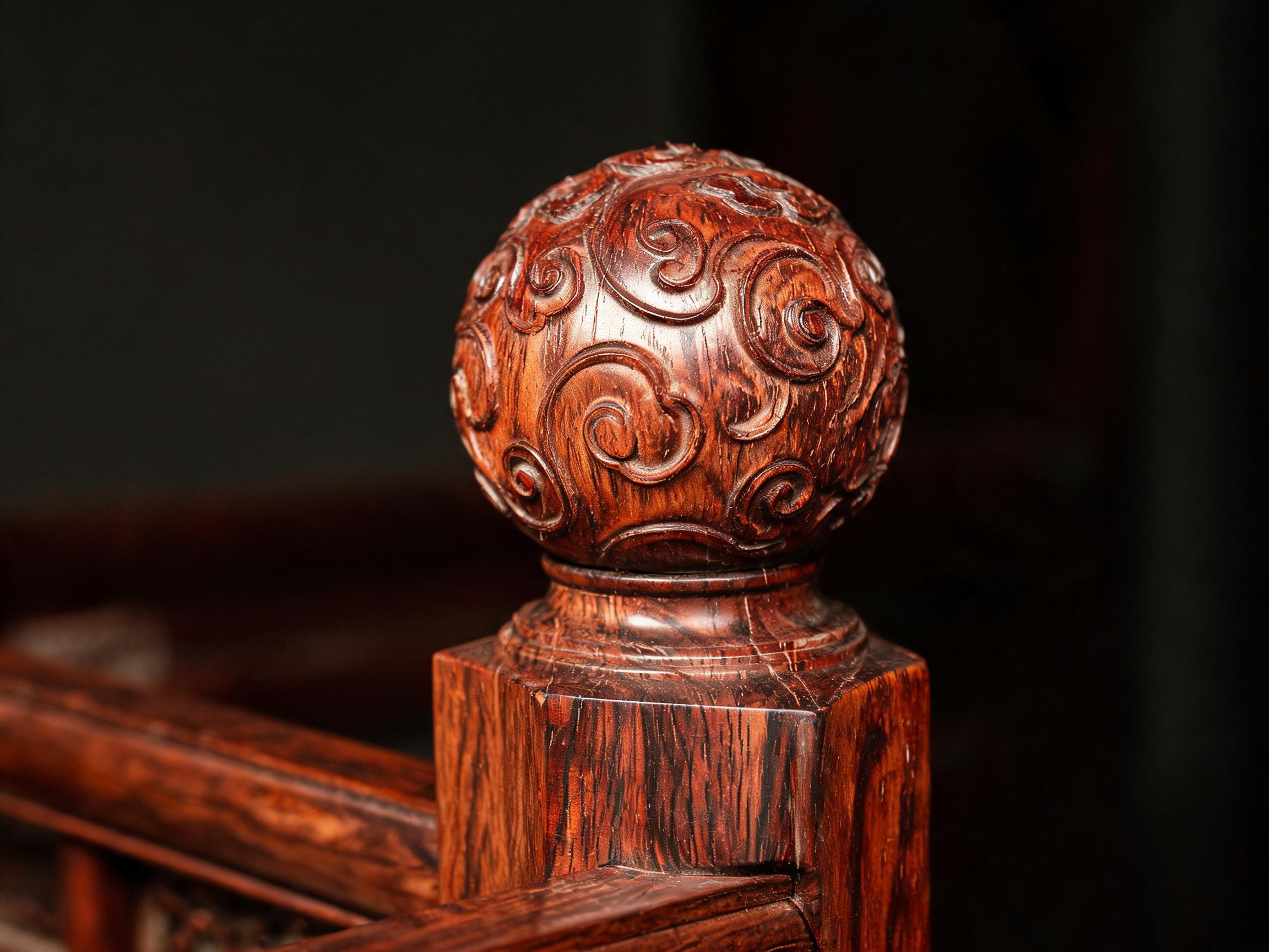 Close-up of a hand-carved and turned rosewood post finial on the four-poster bed, showing crisp chisel marks and raw lacquer sheen