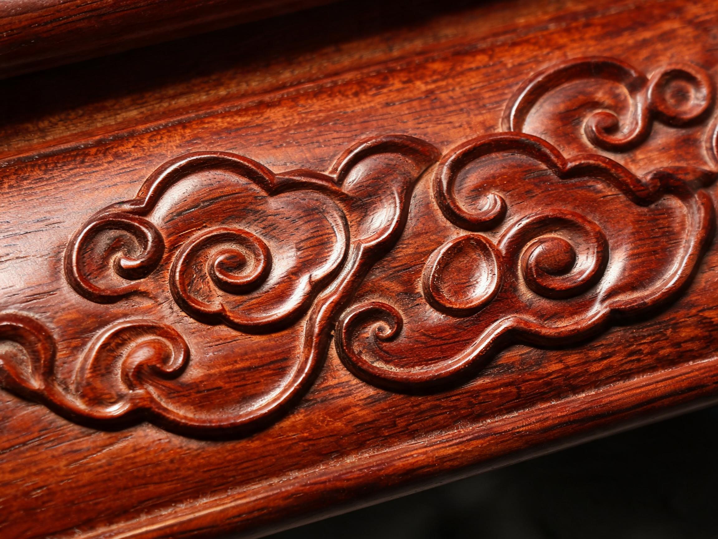 Hand-carved auspicious cloud motif in shallow relief on the Siamese rosewood tea table apron
