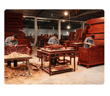 Woodworkers hand-carving rosewood furniture in the Xianyou factory workshop