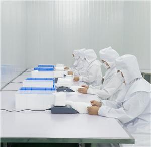 Justsun quality control center – workers in cleanroom suits operating at production workstations