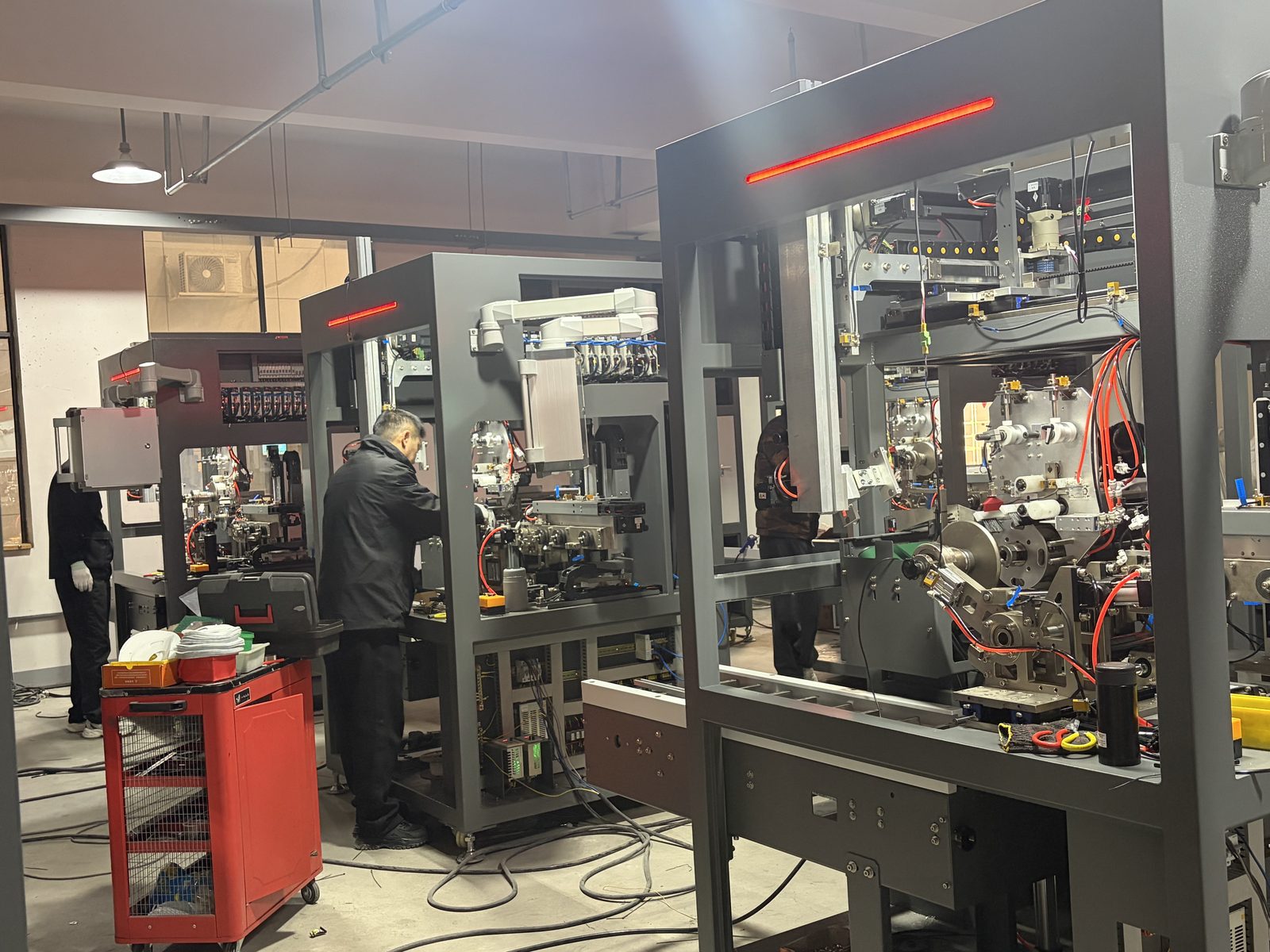 Technicians assembling and commissioning equipment in the workshop