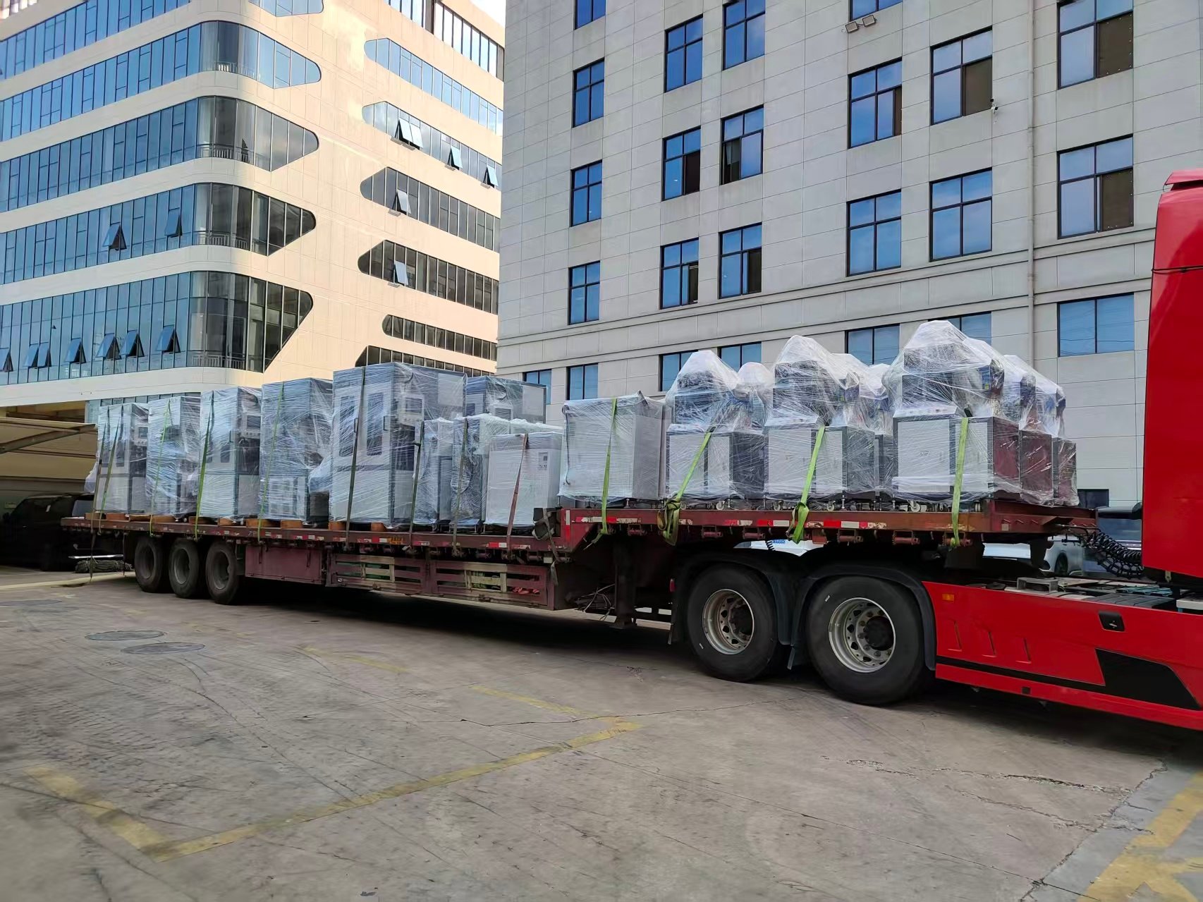 Finished machines wrapped, loaded and secured on trucks for delivery